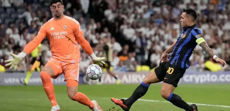 Goalkeeper attempting to block shot during match