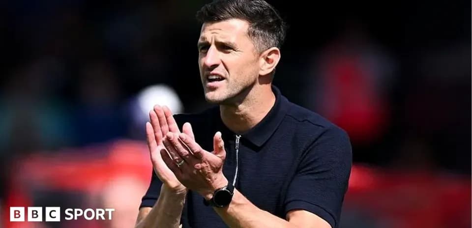 Coach gesturing and clapping during match