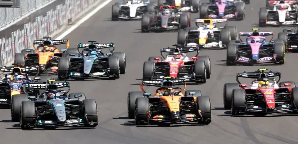 Formula 1 cars racing closely during a competition