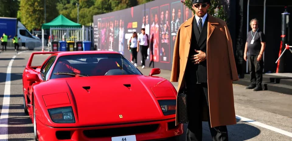 Person in stylish outfit beside red Ferrari F40