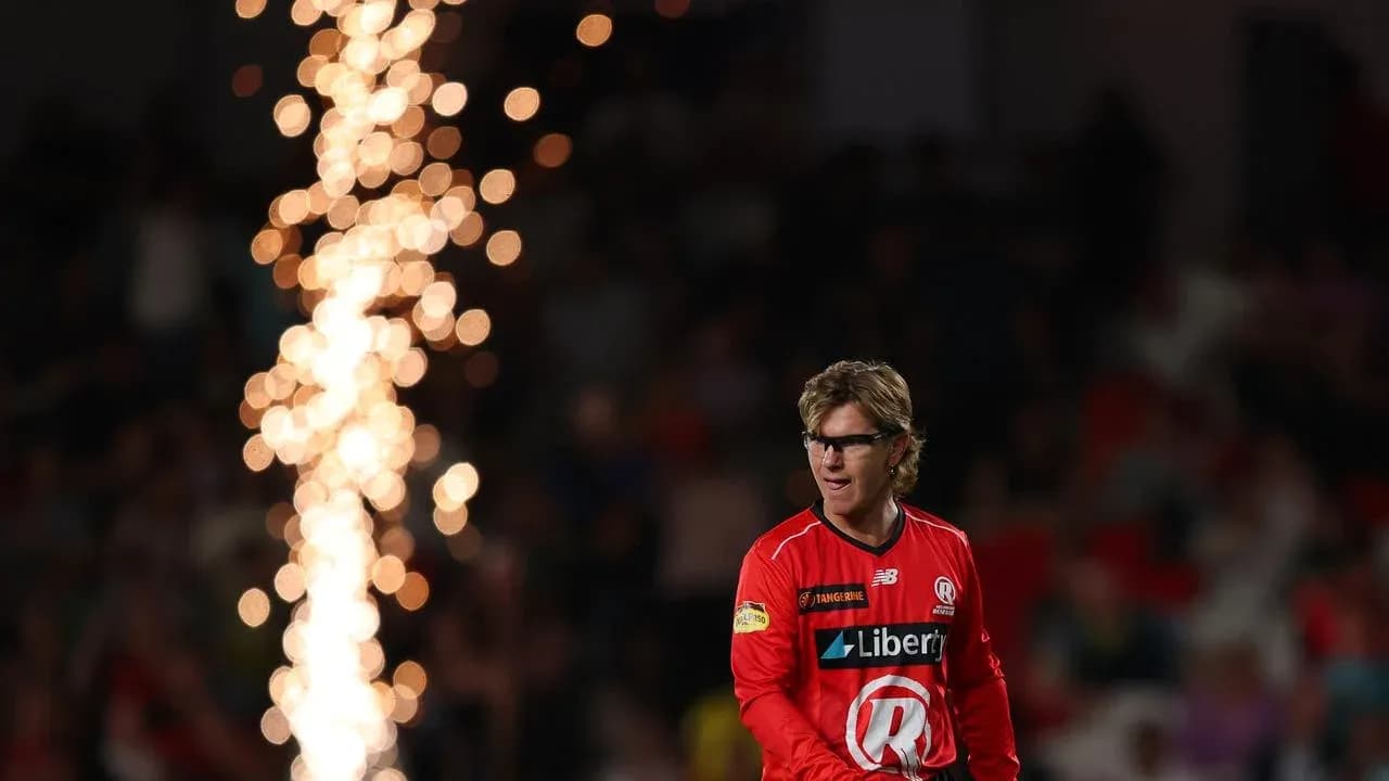 Player in red uniform walking past fireworks display
