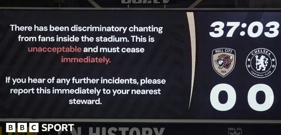 Stadium screen displaying message about discriminatory chanting