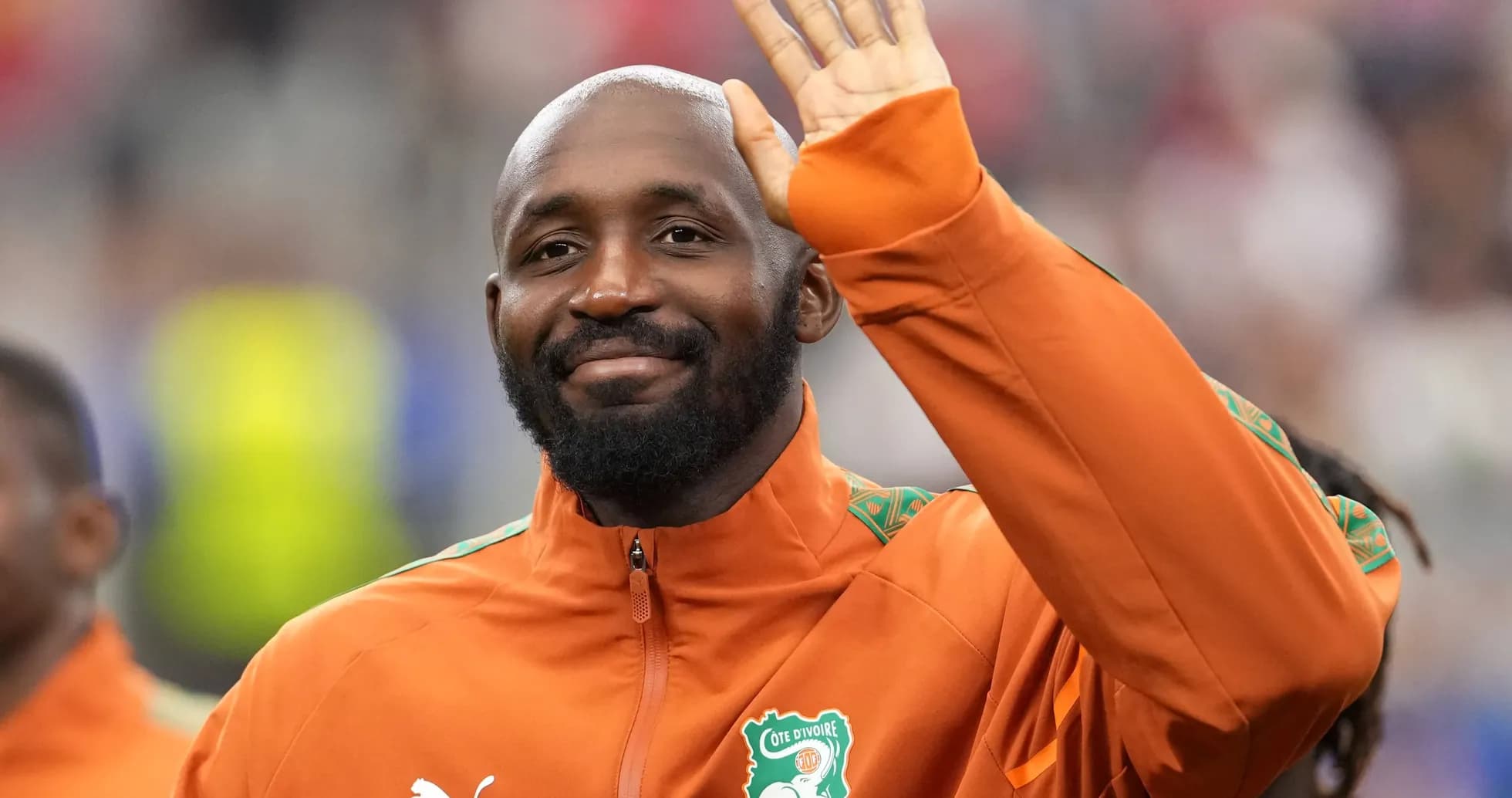 Player waving during team introduction on field