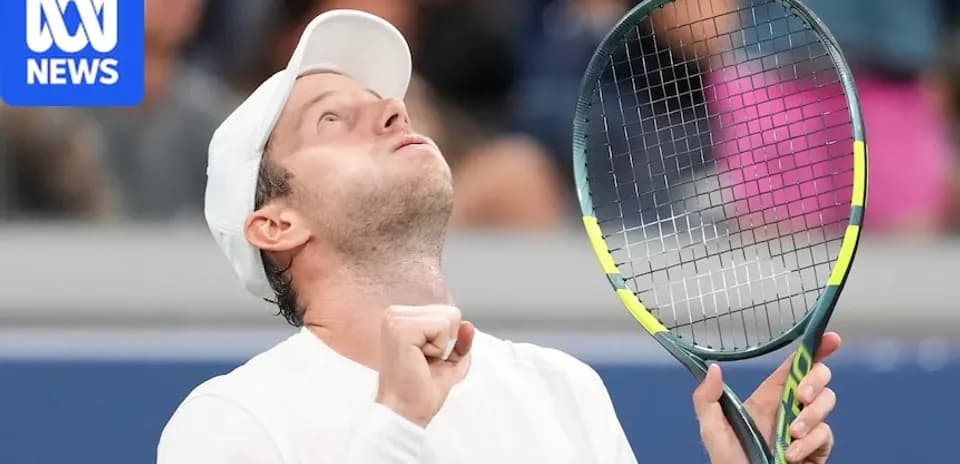 Tennis player celebrating victory with raised racket