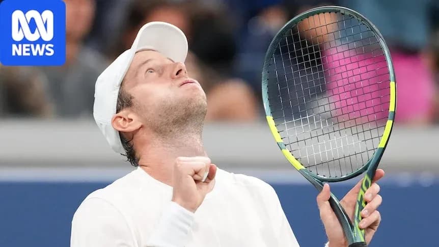 Tennis player celebrating victory with raised racket