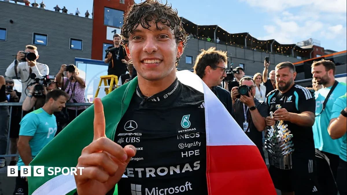 Driver celebrating with Italian flag after race victory