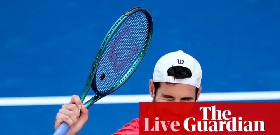 Tennis player celebrating with racket on blue court