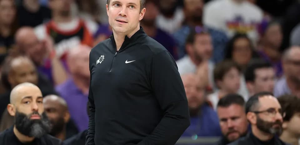Coach observing game from sidelines during match