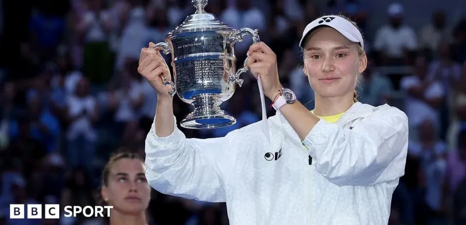 Player holding trophy with runner-up in background