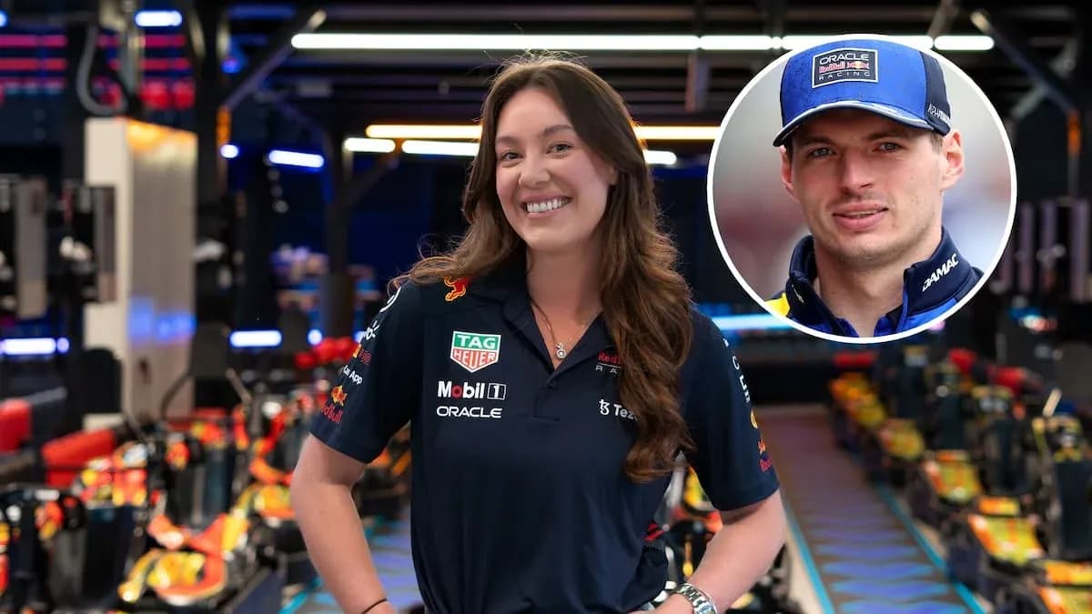 Woman in Red Bull Racing uniform in garage