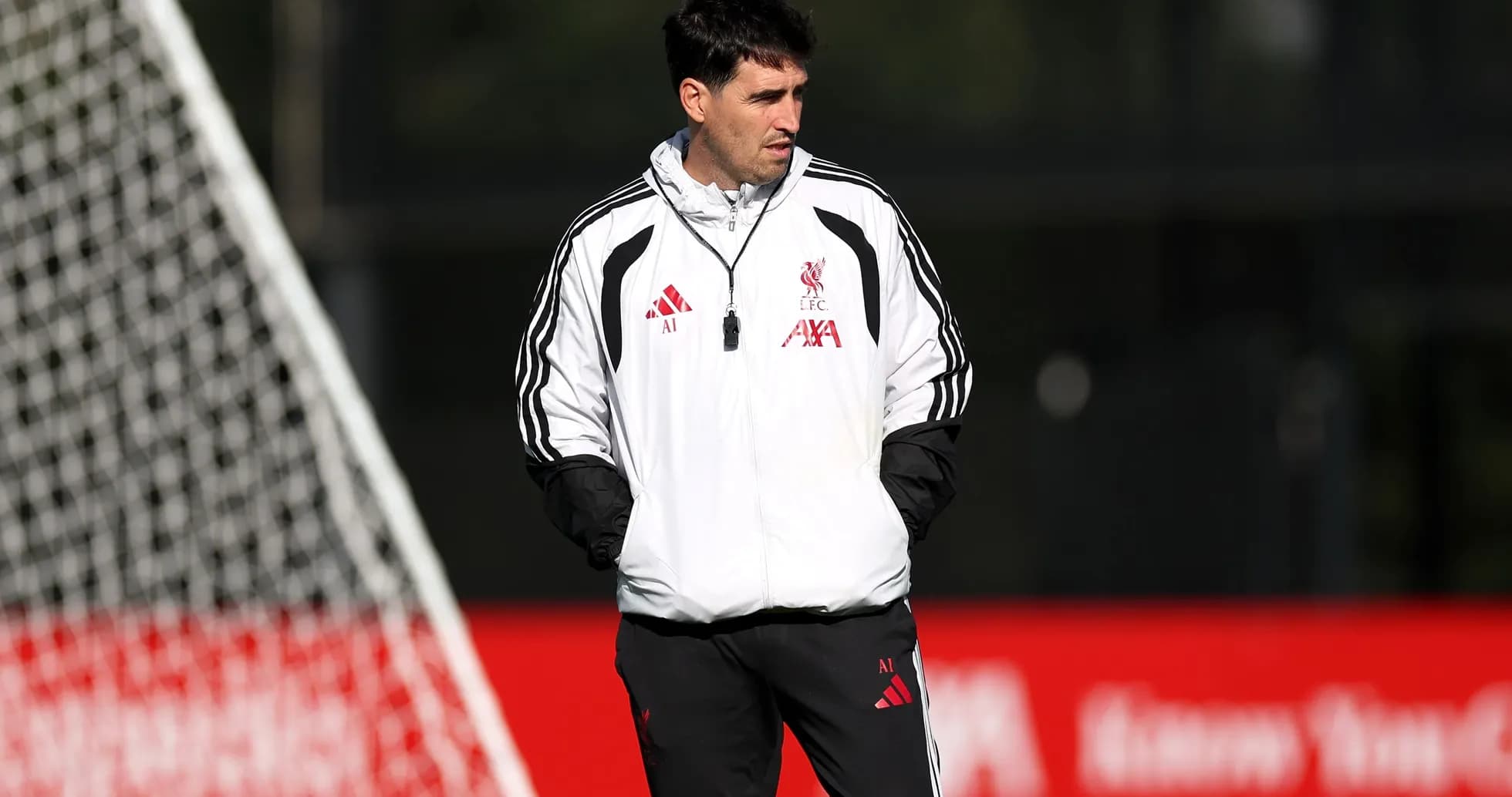 Coach observing players during Liverpool training session