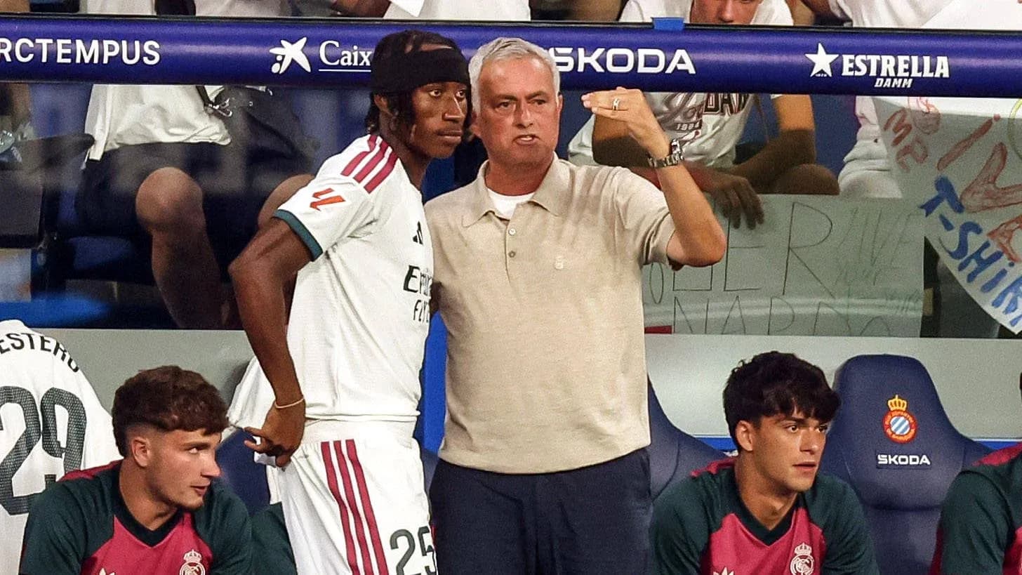 Manager discussing strategy with player on bench