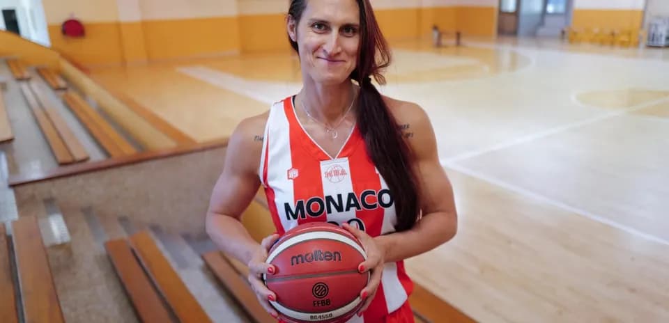Basketball player holding a ball in gym