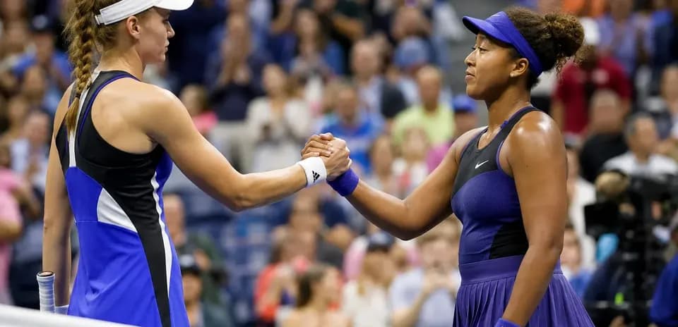 Players shaking hands at the net after match