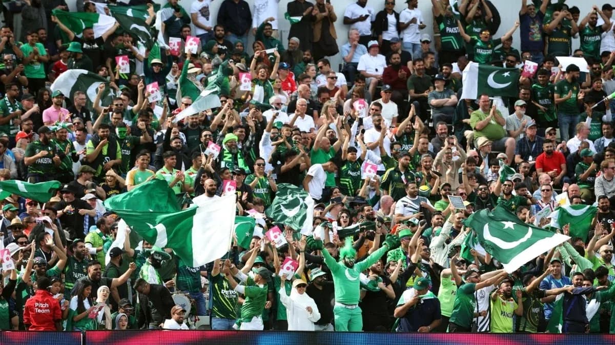 Crowd of fans waving Pakistan flags at match Crowd of fans waving Pakistan flags at match