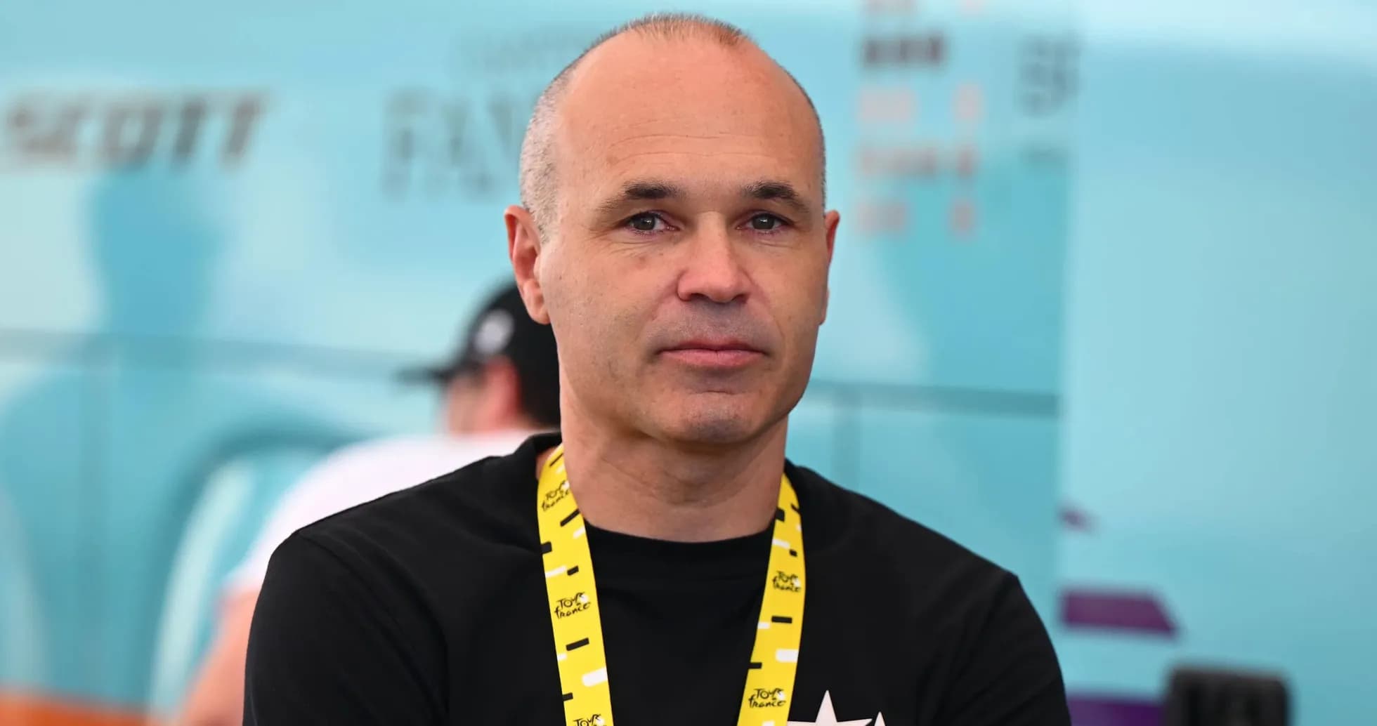 Man wearing a black shirt with a yellow lanyard Man wearing a black shirt with a yellow lanyard