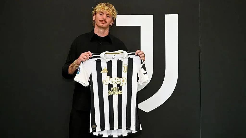 Player holding Juventus jersey at announcement event Player holding Juventus jersey at announcement event