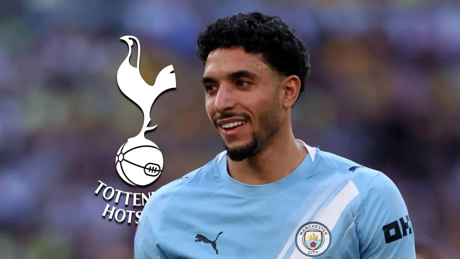 Player smiling in Manchester City kit with logo Player smiling in Manchester City kit with logo