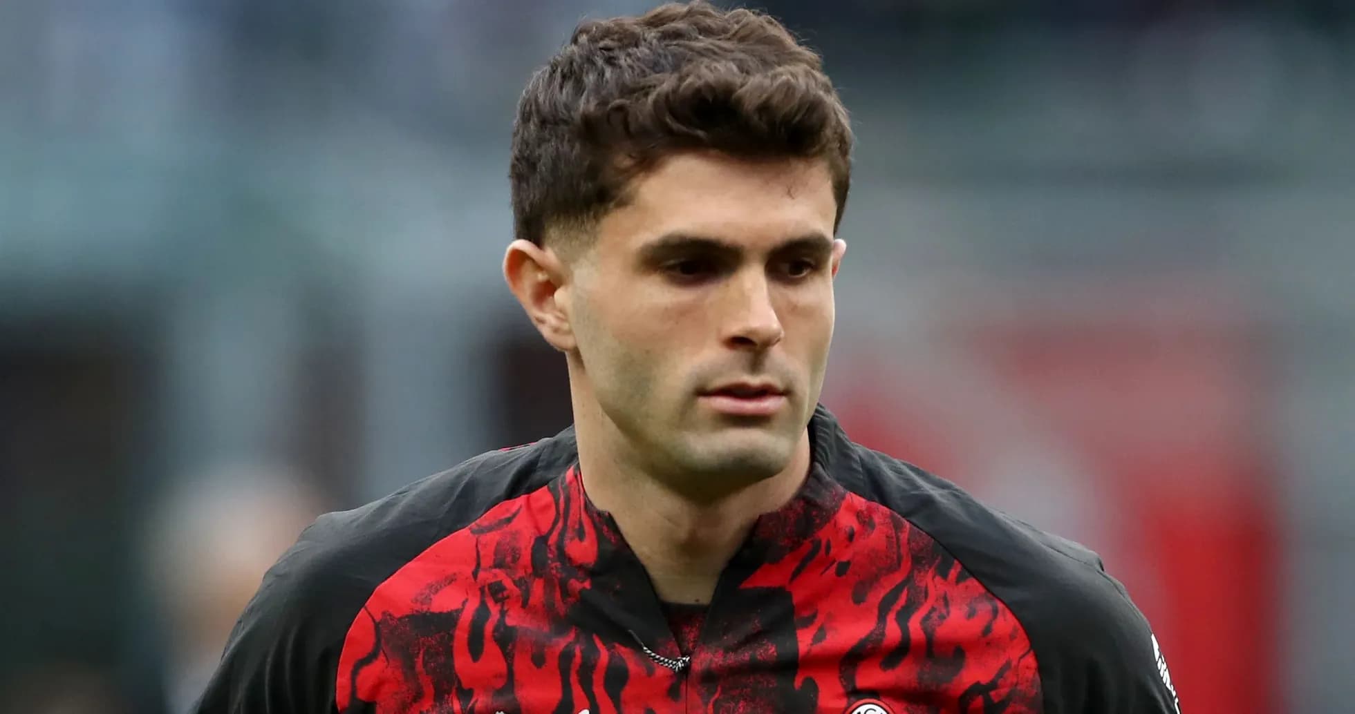 Player walking on the pitch in AC Milan jersey Player walking on the pitch in AC Milan jersey