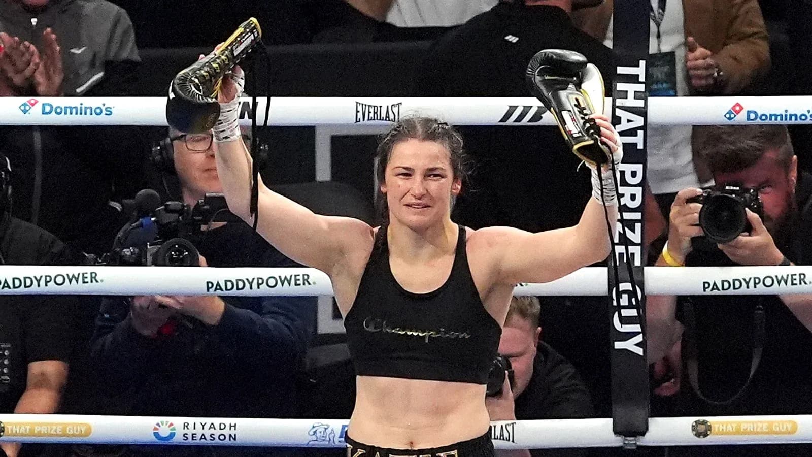 Boxer celebrating victory with championship belts raised Boxer celebrating victory with championship belts raised