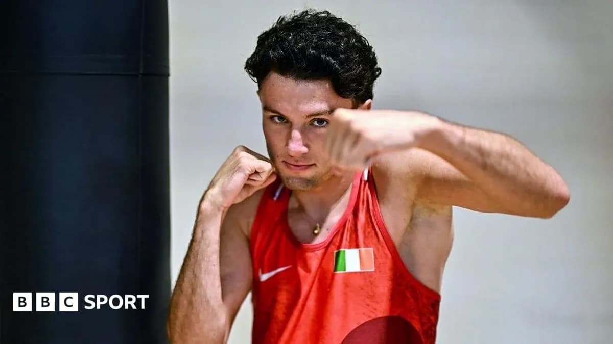 Boxer posing with fist near punching bag Boxer posing with fist near punching bag