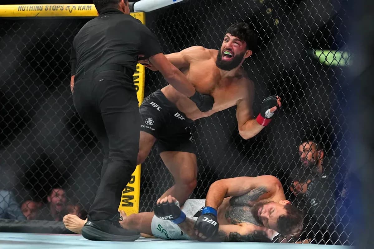 Fighter celebrating while opponent is down on canvas Fighter celebrating while opponent is down on canvas