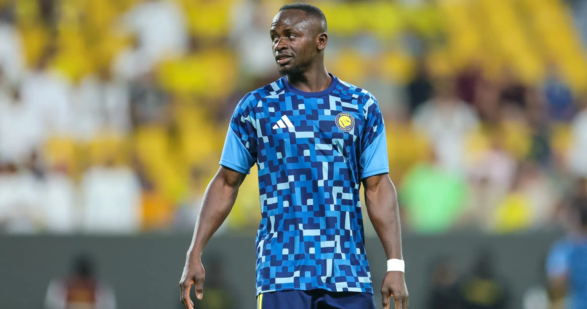 Player in blue patterned jersey on the field Player in blue patterned jersey on the field