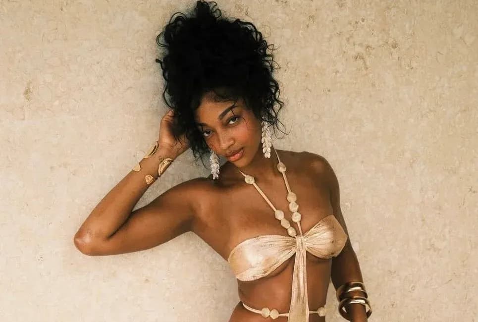 Model posing against a textured beige background Model posing against a textured beige background