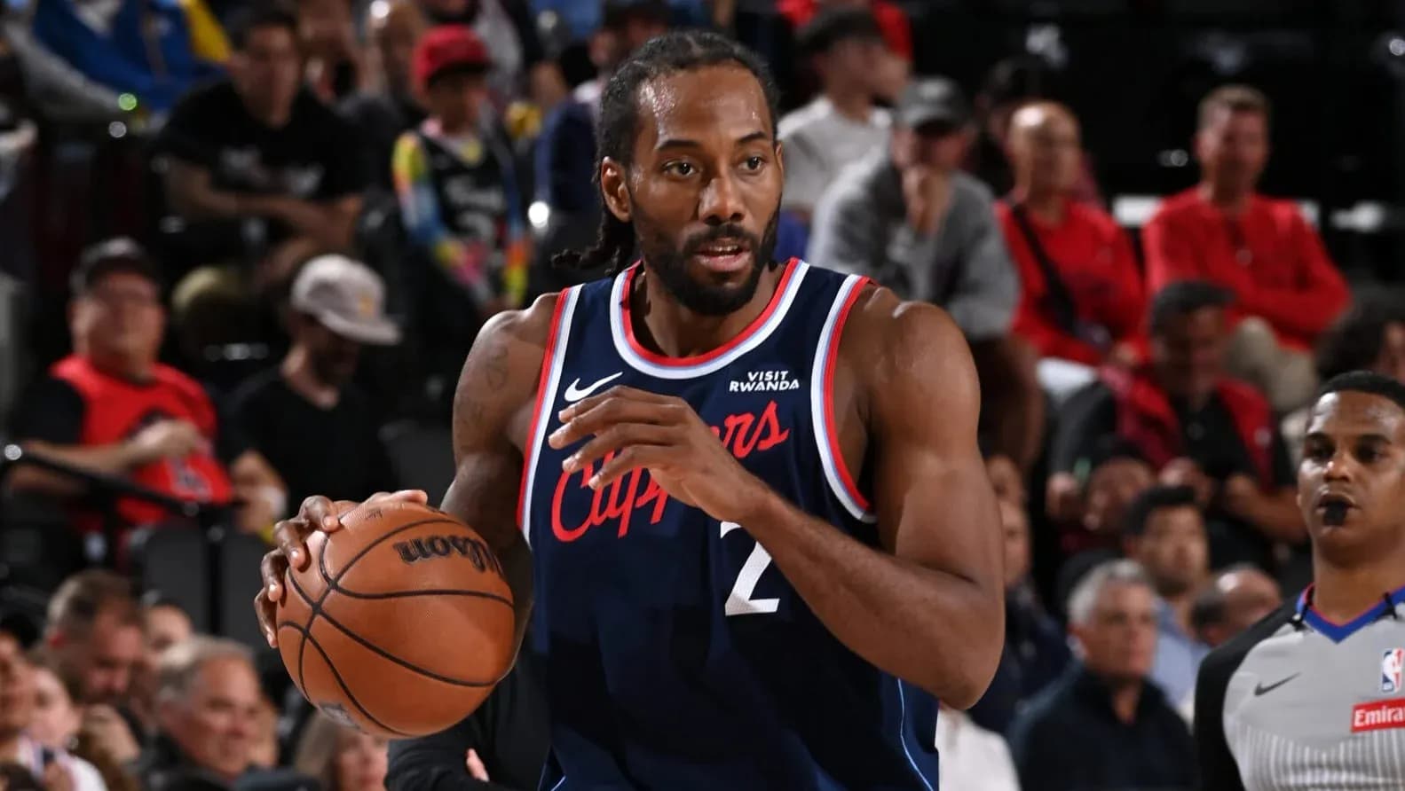 Player dribbling basketball during game action Player dribbling basketball during game action