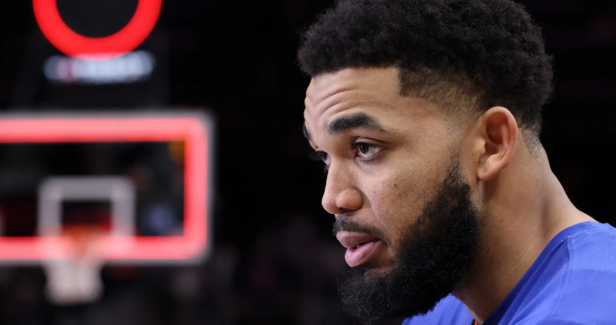 Player sitting near basketball hoop during game Player sitting near basketball hoop during game