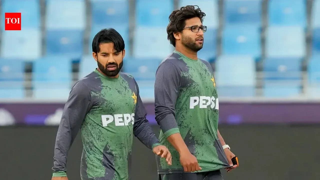 Two Pakistani cricketers walking during practice session Two Pakistani cricketers walking during practice session