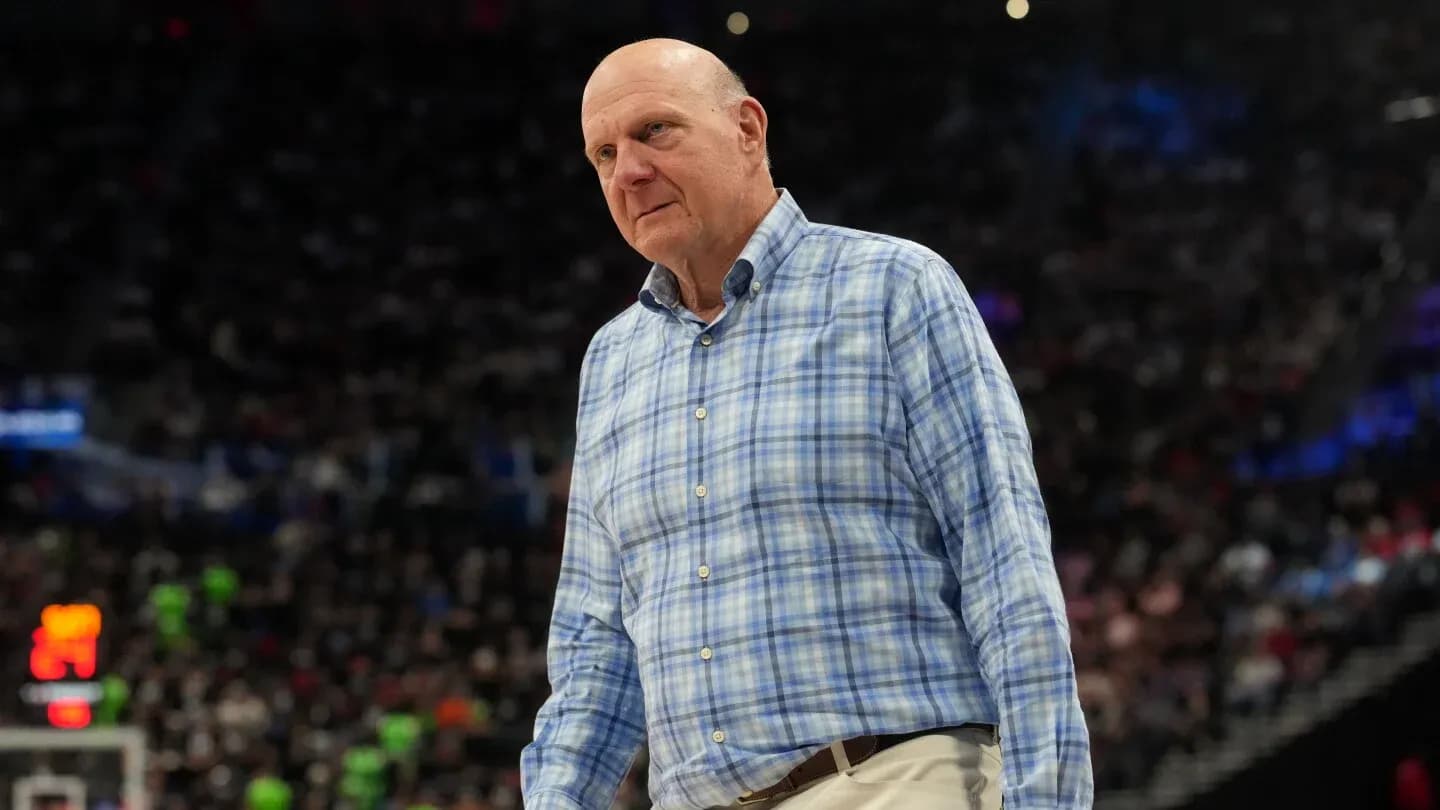 Man in plaid shirt on basketball court sidelines Man in plaid shirt on basketball court sidelines