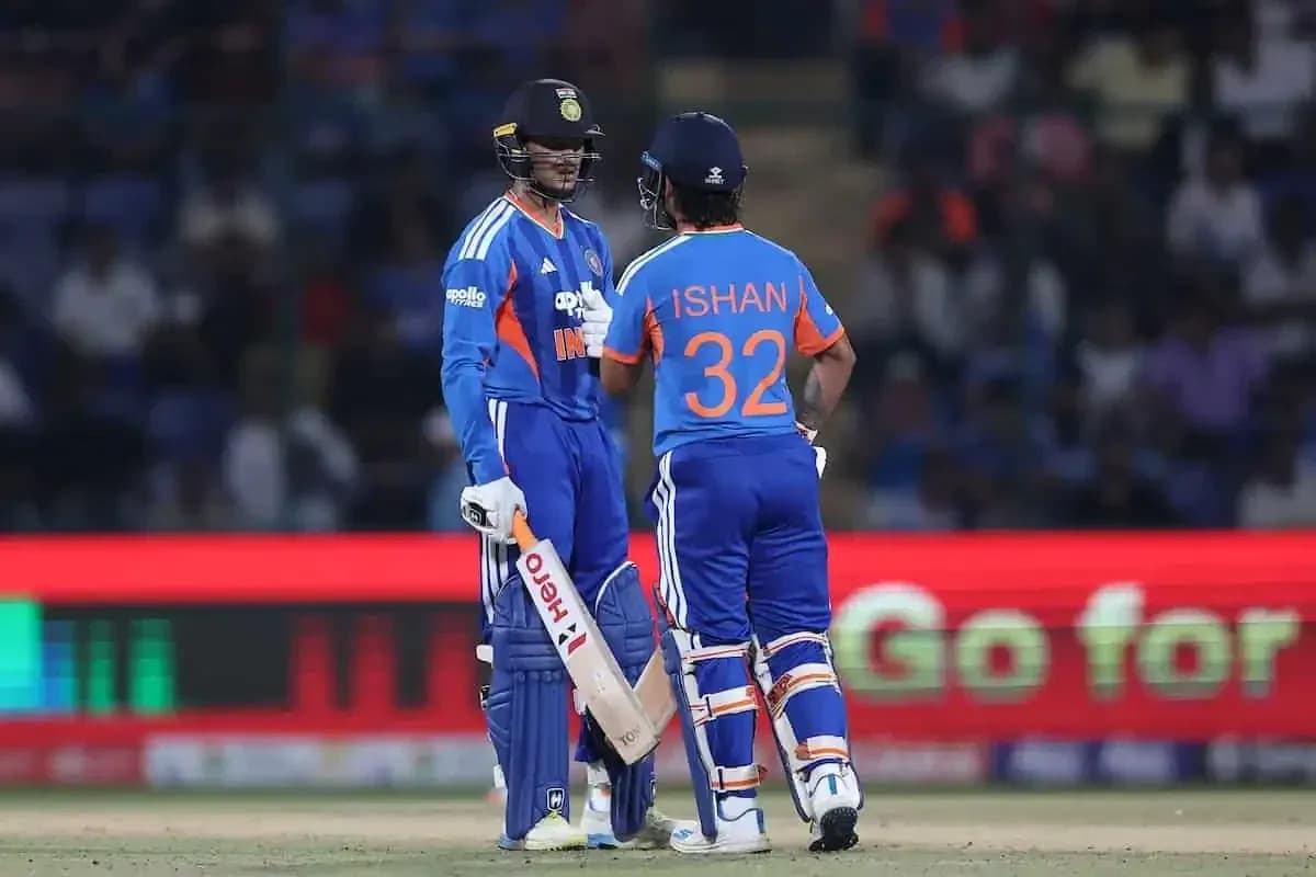 Two Indian cricketers discussing strategy on field Two Indian cricketers discussing strategy on field