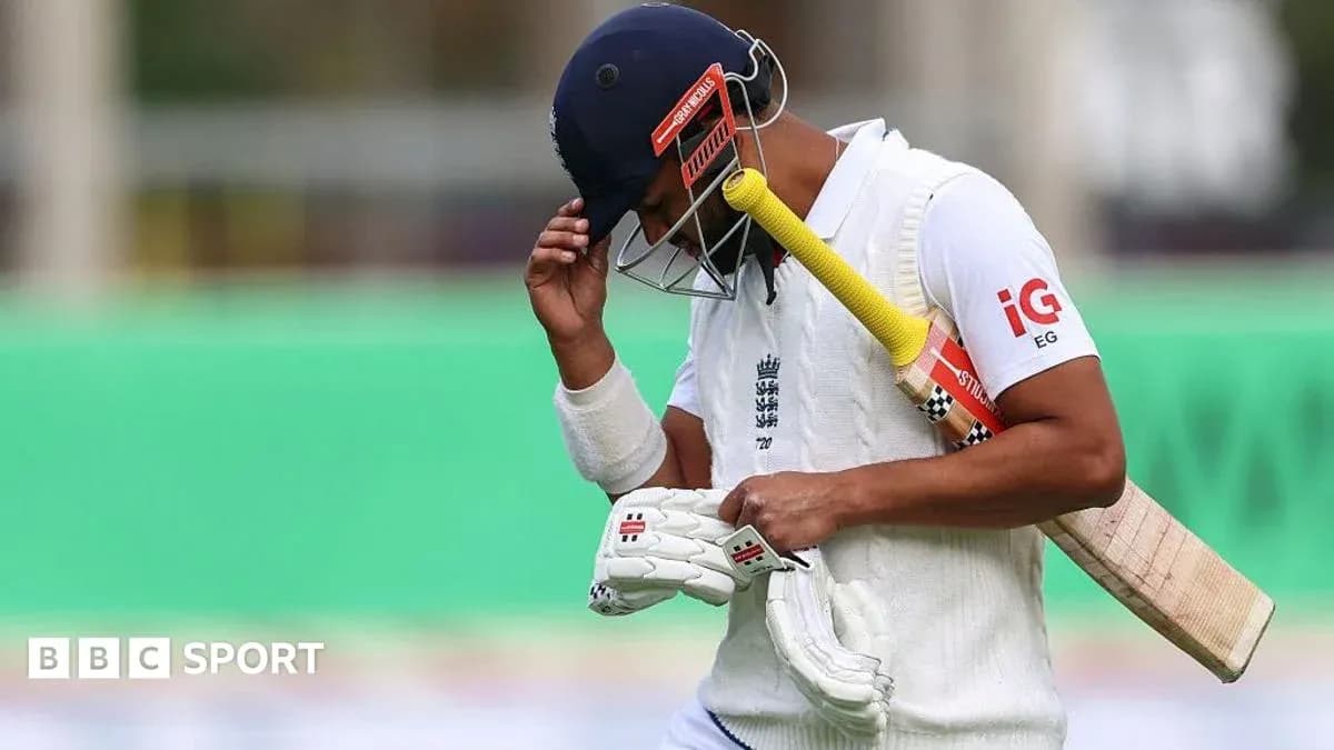 Cricketer walking off field after dismissal Cricketer walking off field after dismissal