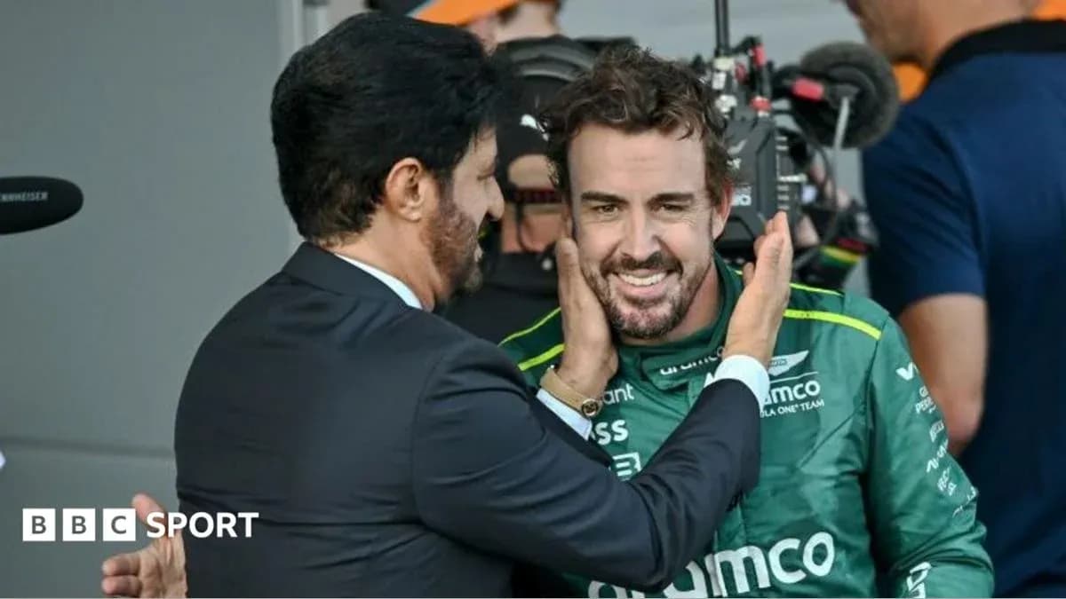 Fernando Alonso celebrating with a team member Fernando Alonso celebrating with a team member