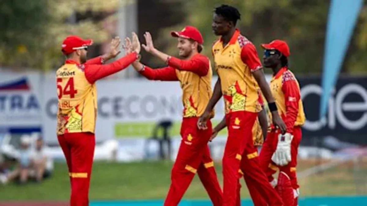 Cricket players celebrating a wicket on the field Cricket players celebrating a wicket on the field