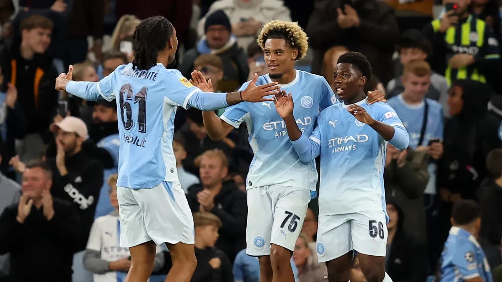 Manchester City players celebrating a goal together Manchester City players celebrating a goal together