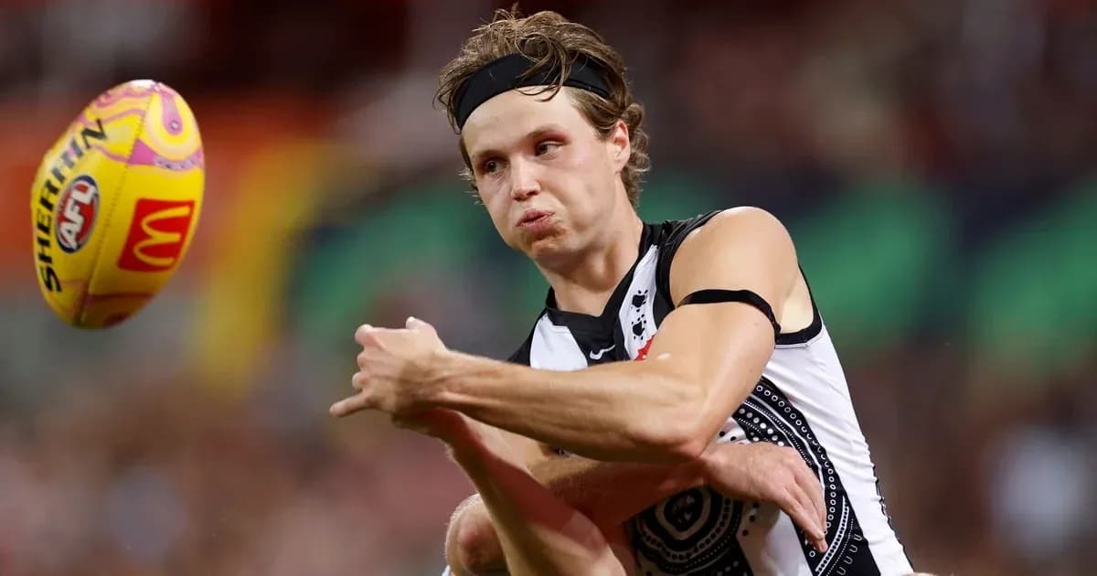 Player kicking an AFL ball during a match Player kicking an AFL ball during a match