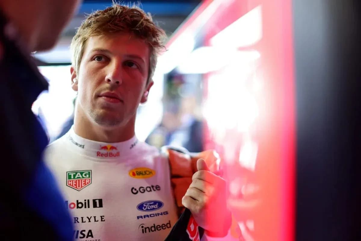 Driver in racing suit preparing in the garage Driver in racing suit preparing in the garage
