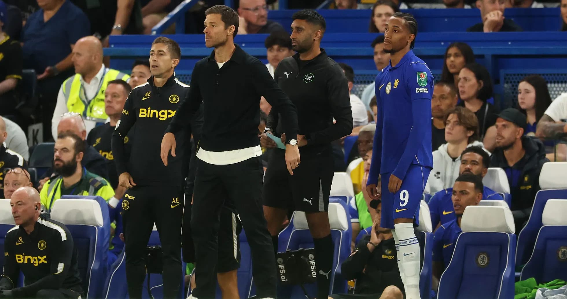 Coaching staff and player on the sidelines during match Coaching staff and player on the sidelines during match