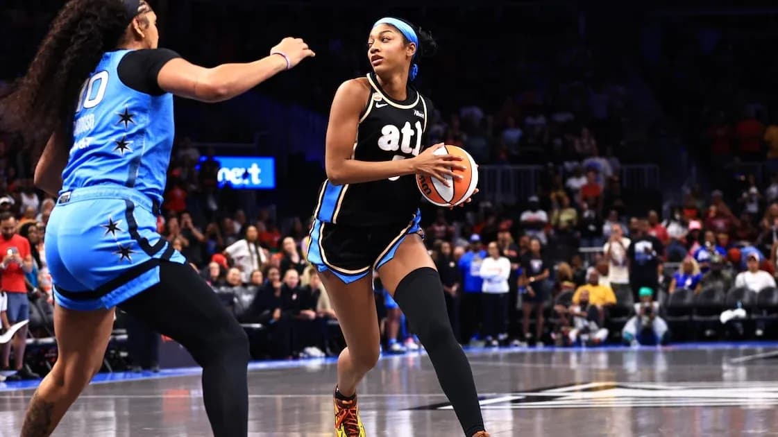 Player dribbling basketball during intense game action Player dribbling basketball during intense game action