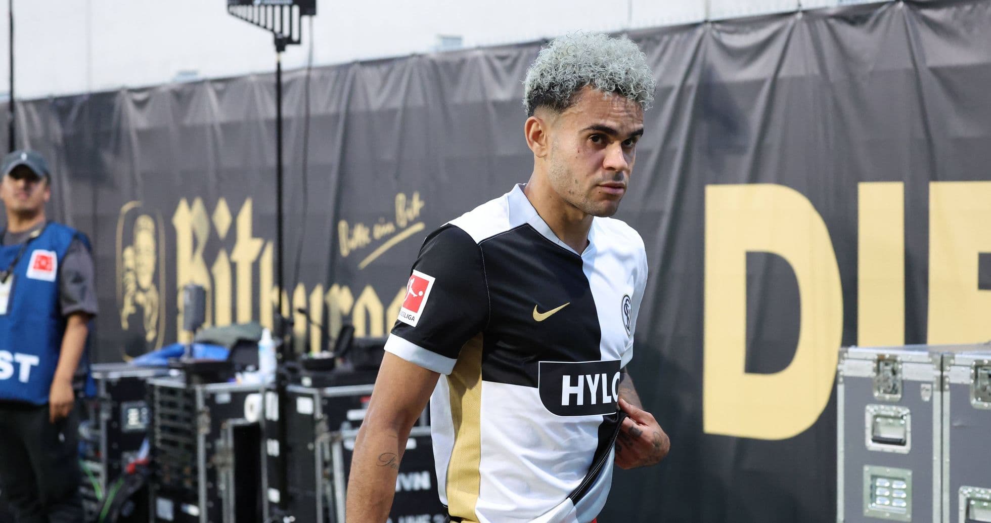 Player walking off the pitch in team uniform Player walking off the pitch in team uniform