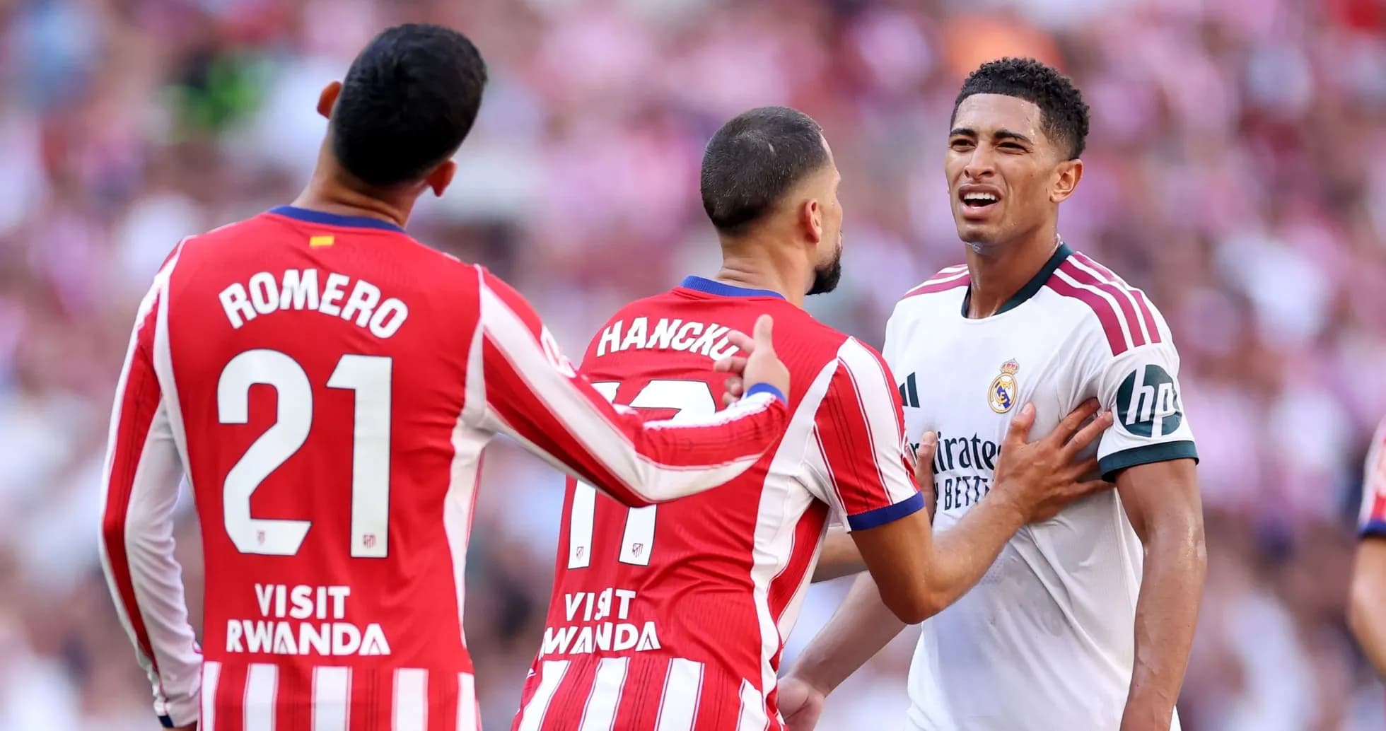 Players from Atlético Madrid confronting a Real Madrid player Players from Atlético Madrid confronting a Real Madrid player