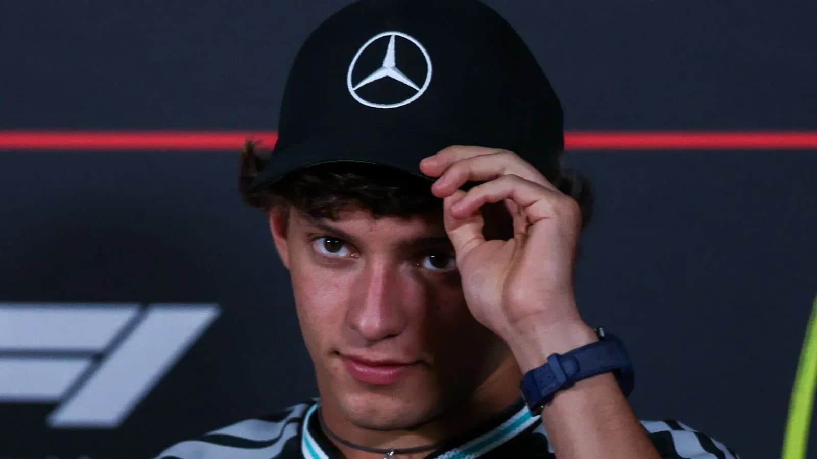 Young man wearing a Mercedes cap at event Young man wearing a Mercedes cap at event