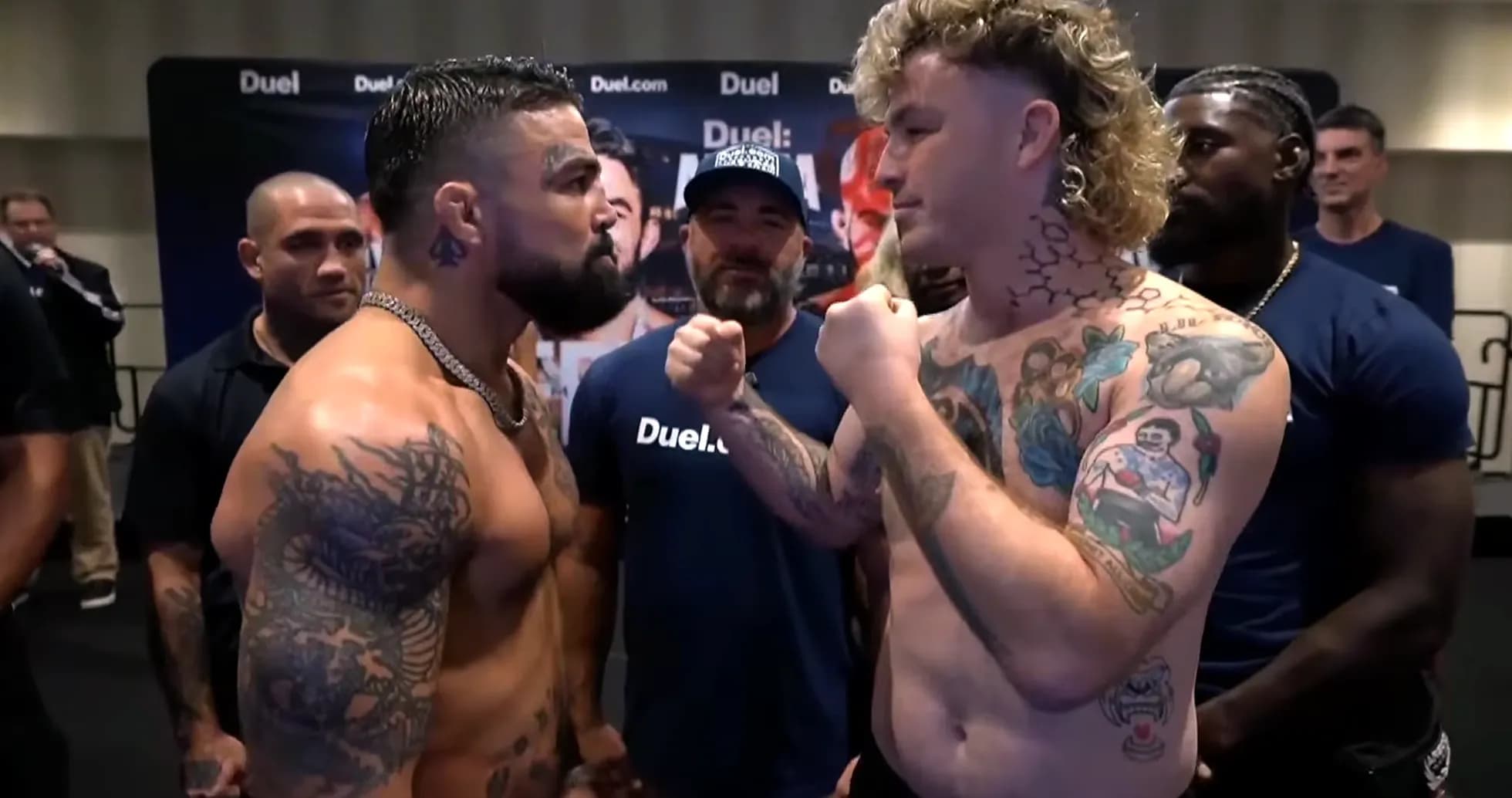 Two fighters facing off during weigh-in event Two fighters facing off during weigh-in event