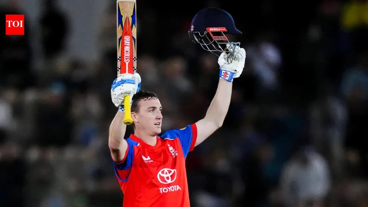 Cricketer celebrating with bat and helmet raised Cricketer celebrating with bat and helmet raised