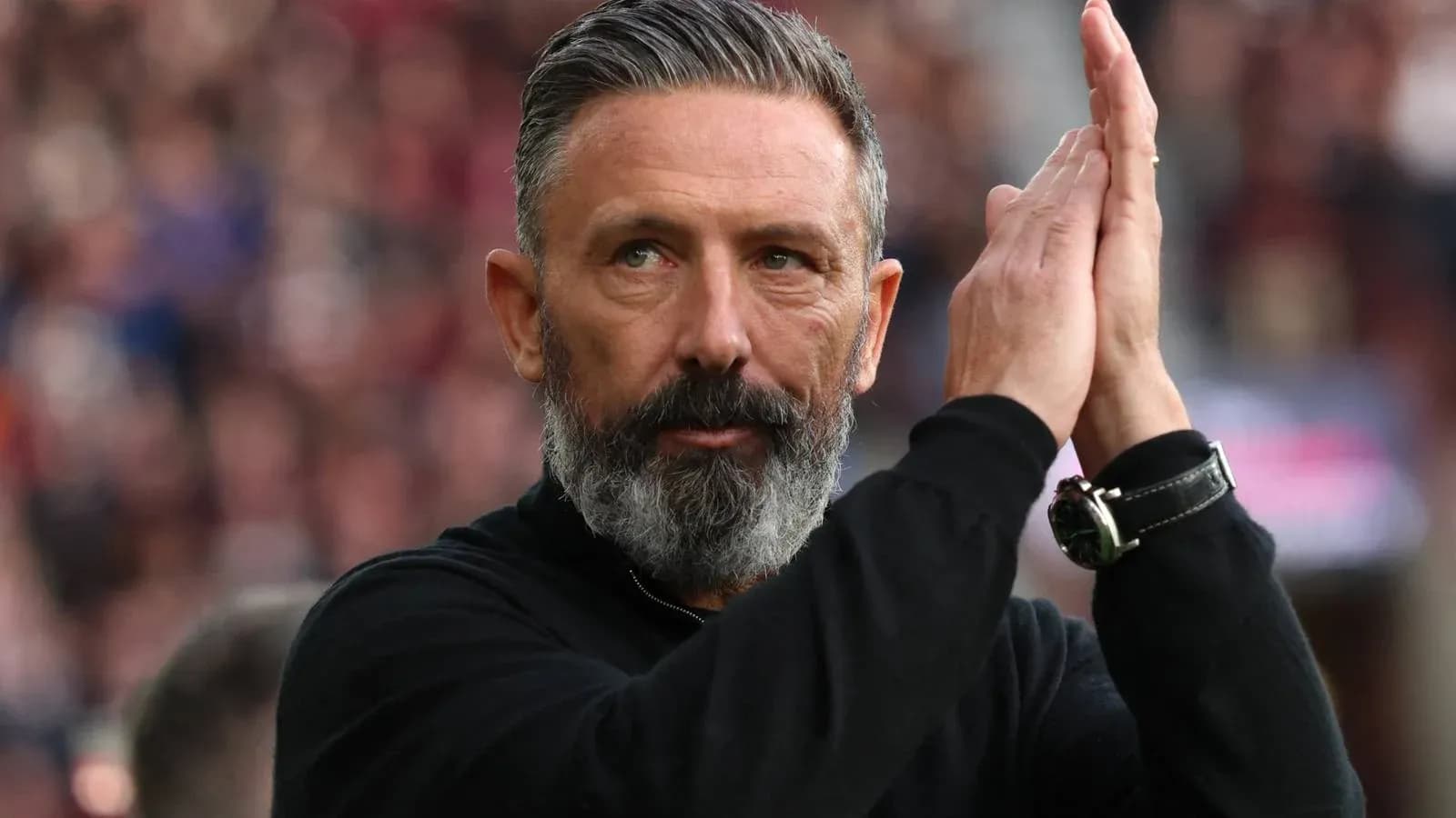 Coach applauding during a match in stadium Coach applauding during a match in stadium