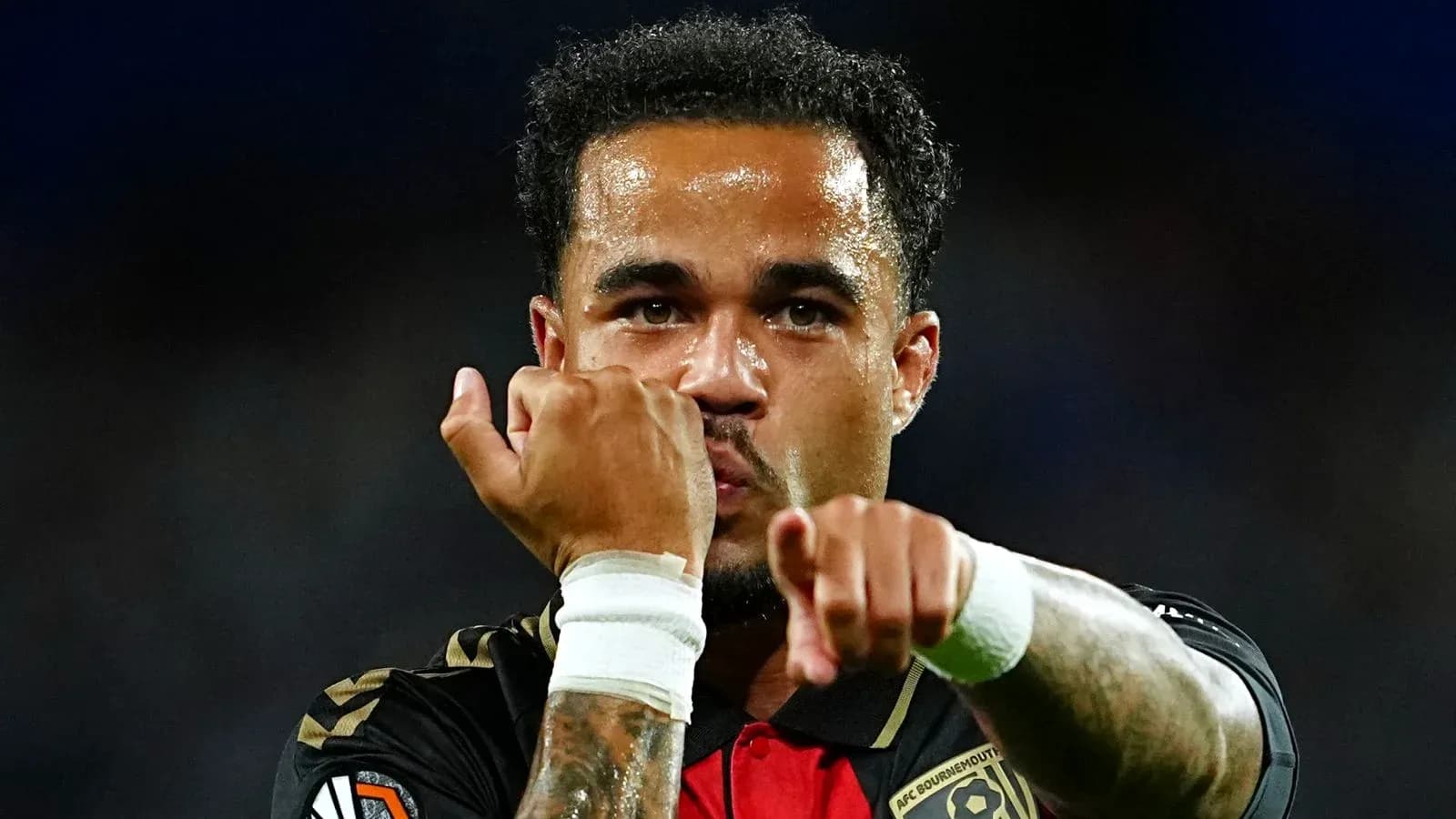 Player celebrating with clenched fists after scoring Player celebrating with clenched fists after scoring