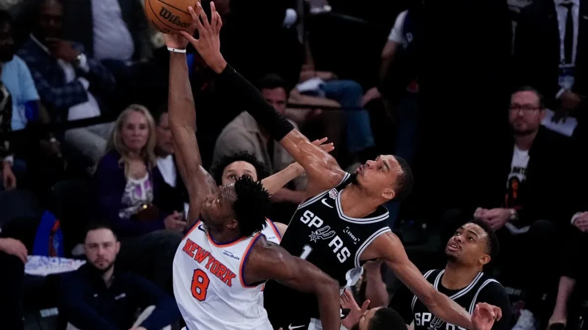 Player attempting a block during basketball game Player attempting a block during basketball game