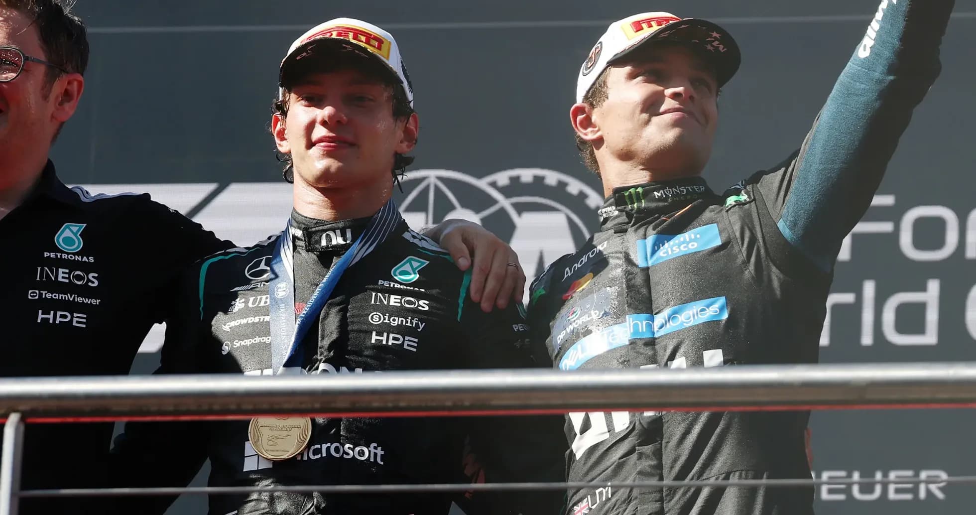 Two drivers celebrating on podium after race Two drivers celebrating on podium after race